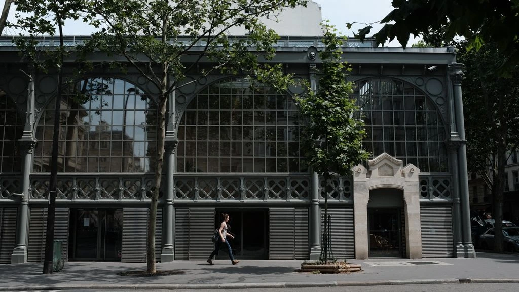 The restored 1898 Haussmannian façade of Hôtel de l'Europe at dusk